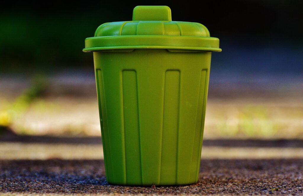 Poubelles dissimulées devant une maison avec claustra bois